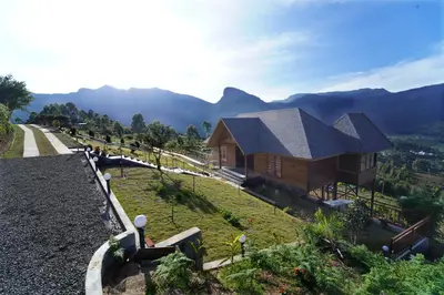 a house on top of a hill with a view at Vrindhavan Farm Suites in Kanthalloor