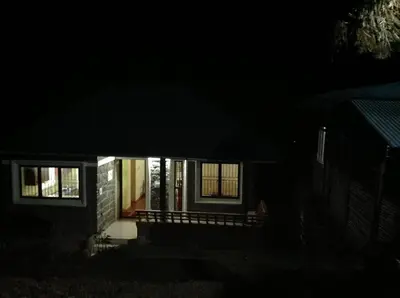 a house at night with the lights on at Vrindhavan Farm Suites in Kanthalloor