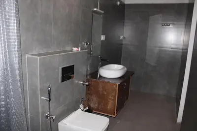 a bathroom with a toilet and a sink and a shower at Coorg Happy Estate Stay in Madikeri