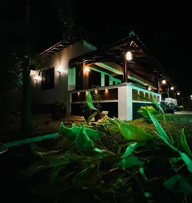 a house at night with lights on it at CHERAI LAKE RESORT in Cherai Beach