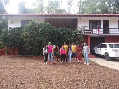 a group of people standing in front of a house at Shree Raksha Homestay in Gonikoppal