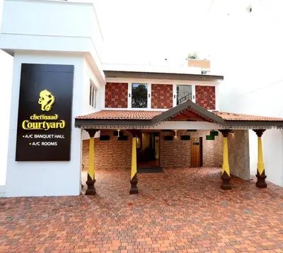a building with a sign on the side of it at Chetinaad Courtyard Gandhipuram by Centre Park in Coimbatore