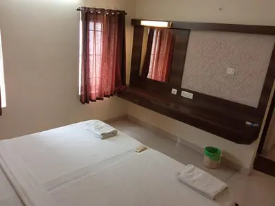 a bedroom with a bed and a large mirror at Chetinaad Courtyard Gandhipuram by Centre Park in Coimbatore