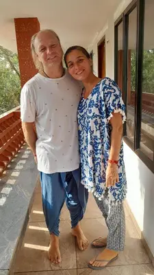 a man and a woman standing on a porch at Dhakshina Homestay in Cochin