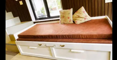 a bed with two pillows sitting on top of it at The Little Acres Cherai in Vypīn