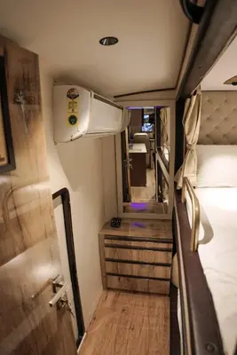 a view of a room with a bed and a mirror at FRONTLINES CARAVAN in Kadikkād
