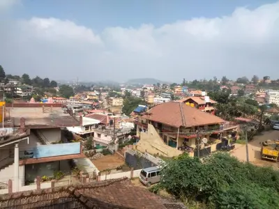 a view of a city with houses and buildings at Prashanth Family Homestay in Madikeri