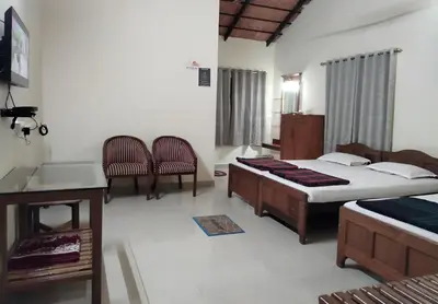 a bedroom with two beds and a sink and a tub at Prashanth Family Homestay in Madikeri