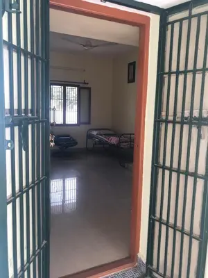 an open door to a room with two beds at Single room Homestay Second floor in Palani
