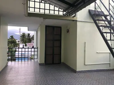 an empty room with a door and a staircase at Single room Homestay Second floor in Palani