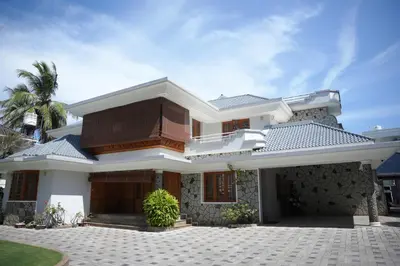 a large white house with a driveway at Alite Posh 4 BHK Villa in Thrissur Town in Trichūr