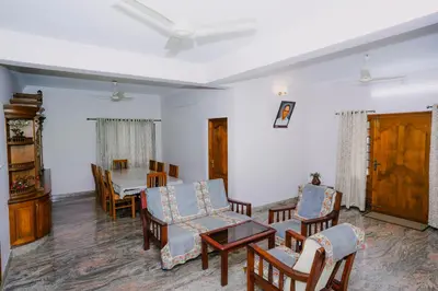 a living room with chairs and a table at Alite Posh 4 BHK Villa in Thrissur Town in Trichūr