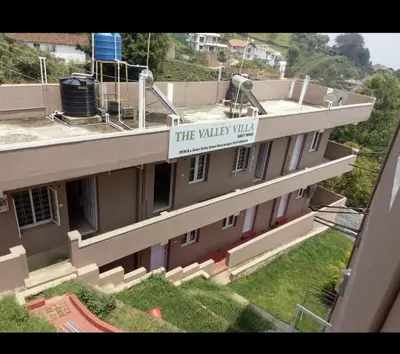 a building with a sign on the side of it at The Valley Villa in Kotagiri