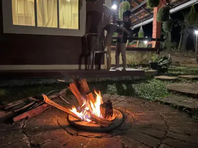 a fire pit in a yard at night at Zyamadhari in Mananthavady