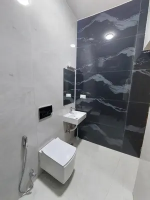 a bathroom with a sink and a toilet and a mirror at Kodai Diva Inn - Home Stay in Kodaikānāl