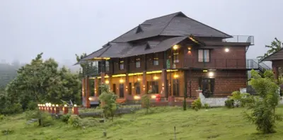 a large house on top of a hill at Misty Valley Resort in Varagampadi