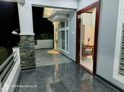 a hallway of a house with a glass door at Peppercorn Cottage, Vythiri. in Vythiri