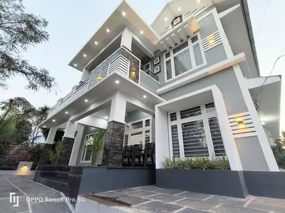 a large white house with at Peppercorn Cottage, Vythiri. in Vythiri