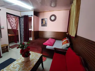 a small living room with a couch and a table at AKS Home Stay in Munnar