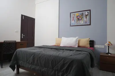 a bedroom with a bed and a picture on the wall at AVANTI CASTELLO in Guruvāyūr