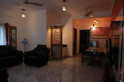 a living room with a couch and a table at AVANTI CASTELLO in Guruvāyūr