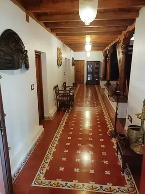a hallway of a house with a tile floor at Kalappura Farm House Heritage in Ottappālam