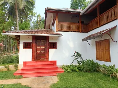 a house with red steps in front of it at Kalappura Farm House Heritage in Ottappālam