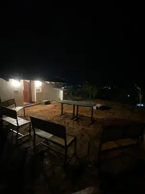 a ping pong table and chairs at night at Mercara Aloft in Madikeri