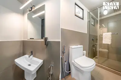 a bathroom with a toilet and a sink and a shower at StayVista at Griha Sankalpa with Mountain View, BBQ Wayanad in Koroth