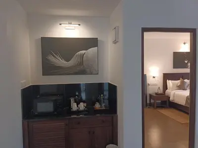 a room with a bedroom with a bed and a mirror at Dvara Luxury Resort Kodaikanal in Kodaikānāl