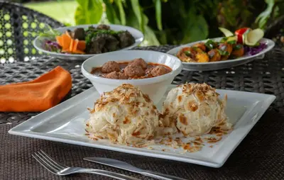 a plate with twooops of food on a table at Dvara Luxury Resort Kodaikanal in Kodaikānāl