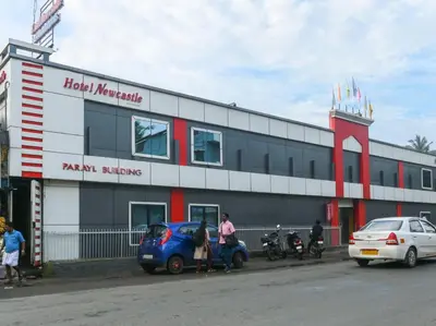 a building with a car parked in front of it at HOTEL NEWCASTLE in Vadakkāncheri