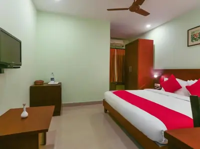 a bedroom with a large bed and a tv at HOTEL NEWCASTLE in Vadakkāncheri