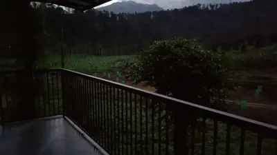 a balcony with a view of a mountain at Teaside Inns in Vythiri