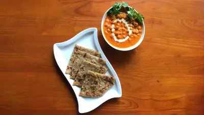 a white plate with three sandwiches and a bowl of soup at Mount Stratus Resort Vayalada in Bālūssheri