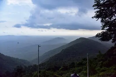 a view of a valley with mountains in the distance at Mount Stratus Resort Vayalada in Bālūssheri