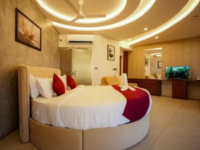 a bedroom with a large bed in a room at Mount Stratus Resort Vayalada in Bālūssheri
