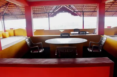 a dining room with a table and chairs at Holidayincoorg Royal Mansion in Madikeri
