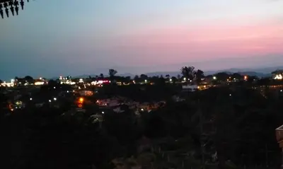 a view of a city at night at Holidayincoorg Royal Mansion in Madikeri