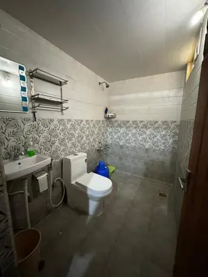 a bathroom with a toilet and a sink at Rustic Village Farmhouse in Bengaluru