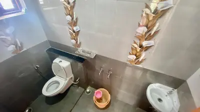 a bathroom with a toilet and a sink at Mountain Mansion Kodai in Kodaikānāl