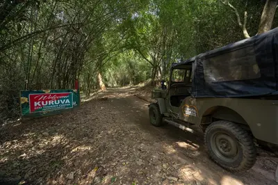 a military truck parked on a dirt road with a sign at Crystal Kuruva Nature Resort & Spa in Wayanad