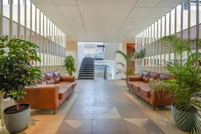 a lobby with leather couches and potted plants at HOTEL CASON INTERNATIONAL in Kondotti