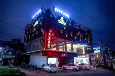 a building with cars parked in front of it at night at HOTEL CASON INTERNATIONAL in Kondotti