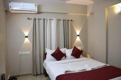 a bedroom with a bed with red and white pillows at Dreams Paradise Airport Residency in Nedumbassery
