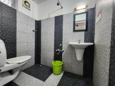a bathroom with a sink and a toilet at Navarang Villa in Kalpetta