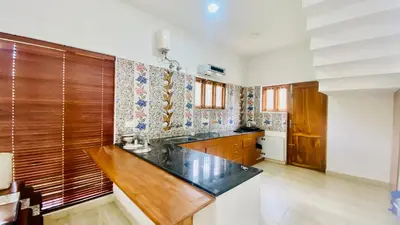 a kitchen with a wooden counter top in a room at Mountain Abode in Kodaikānāl
