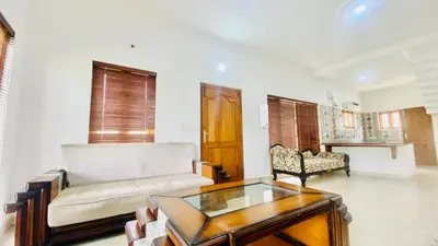 a living room with a couch and a coffee table at Mountain Abode in Kodaikānāl