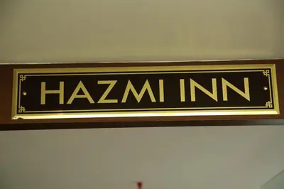 a sign that says hamini on a wall at hazmi inn in Perintalmanna