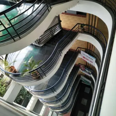 an overhead view of an escalator in a building at hazmi inn in Perintalmanna